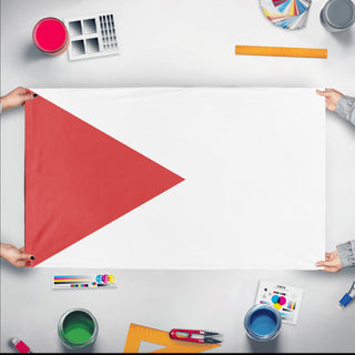 A mockup of the custom flag 'T flag' held up on a table during print checking