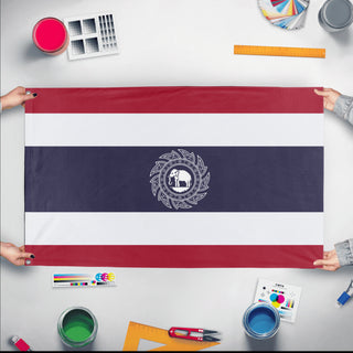 A mockup of the custom flag 'Custom Fictional Thai flag' held up on a table during print checking