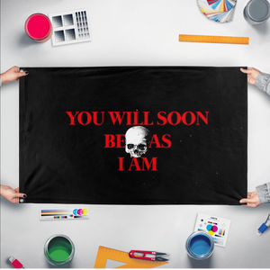A mockup of the custom flag 'You will soon be as I am flag' held up on a table during print checking