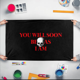A mockup of the custom flag 'You will soon be as I am flag' held up on a table during print checking