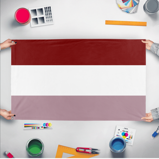 A mockup of the custom flag 'National Queer Flag' held up on a table during print checking