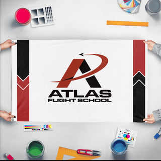 A mockup of the custom flag 'Atlas Flight School flag' held up on a table during print checking