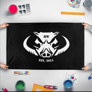 A mockup of the custom flag 'HW flag' held up on a table during print checking