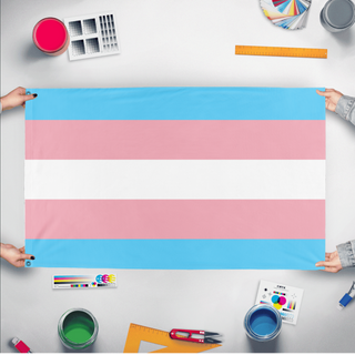 A mockup of the custom flag 'Trans flag' held up on a table during print checking