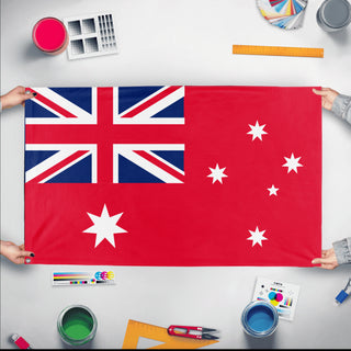 A mockup of the custom flag 'Red Australia flag' held up on a table during print checking