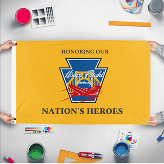 A mockup of the custom flag 'HFP-HONH-Gold flag' held up on a table during print checking