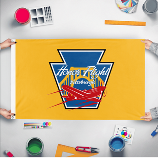A mockup of the custom flag 'HFP-Gold flag' held up on a table during print checking