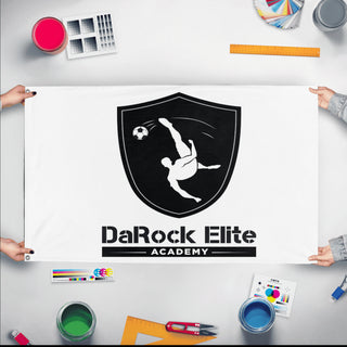 A mockup of the custom flag 'DaRock flag' held up on a table during print checking