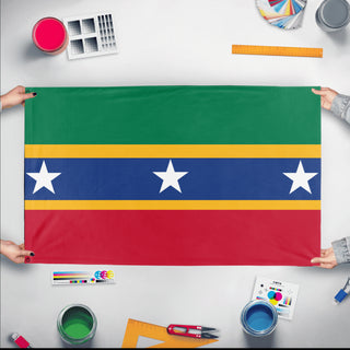 A mockup of the custom flag 'komful flag' held up on a table during print checking