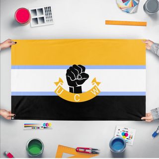 A mockup of the custom flag 'UCW flag' held up on a table during print checking