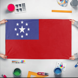 A mockup of the custom flag 'SMALL FREE REPUBLIC OF DONKK  flag' held up on a table during print checking