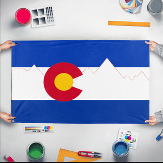 A mockup of the custom flag 'Colorado  redesign   flag' held up on a table during print checking
