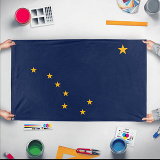 A mockup of the custom flag 'Alaska State Flag' held up on a table during print checking