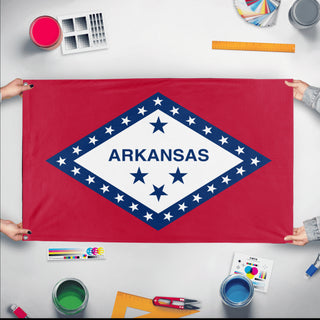 A mockup of the custom flag 'Arkansas State Flag' held up on a table during print checking