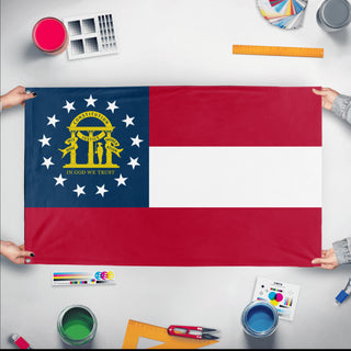 A mockup of the custom flag 'Georgia State Flag' held up on a table during print checking