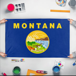A mockup of the custom flag 'Montana State Flag' held up on a table during print checking