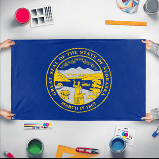 A mockup of the custom flag 'Nebraska State Flag' held up on a table during print checking