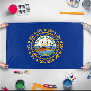 A mockup of the custom flag 'New Hampshire State Flag' held up on a table during print checking