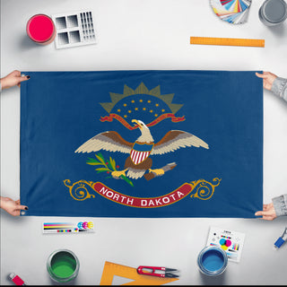 A mockup of the custom flag 'North Dakota State Flag' held up on a table during print checking