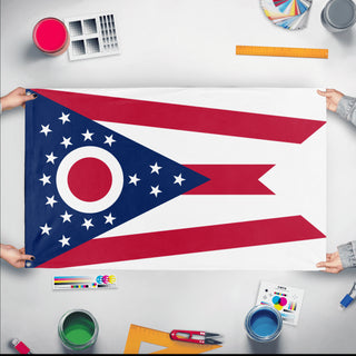 A mockup of the custom flag 'Ohio State Flag' held up on a table during print checking