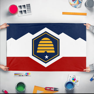 A mockup of the custom flag 'Utah State Flag' held up on a table during print checking