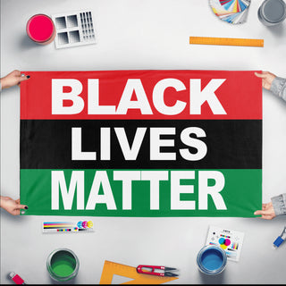 A mockup of the custom flag 'Pan-African Black Lives Matter Flag' held up on a table during print checking