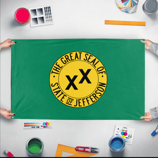 A mockup of the custom flag 'State of Jefferson flag' held up on a table during print checking