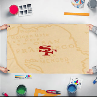 A mockup of the custom flag '9ers flag' held up on a table during print checking