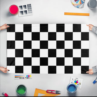 A mockup of the custom flag 'Black and white Checkered Racing Flag' held up on a table during print checking