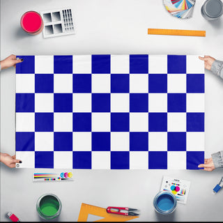 A mockup of the custom flag 'Blue and White Checkered Flag' held up on a table during print checking