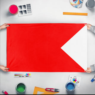 A mockup of the custom flag 'Bravo Signal Flag' held up on a table during print checking