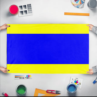 A mockup of the custom flag 'Delta Signal Fla flag' held up on a table during print checking
