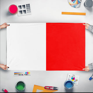 A mockup of the custom flag 'Hotel Signal Flag' held up on a table during print checking