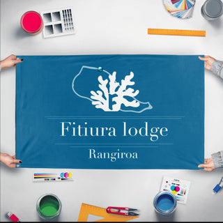 A mockup of the custom flag 'Rangi flag' held up on a table during print checking