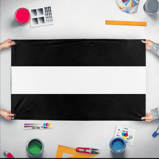 A mockup of the custom flag 'Black and White Striped Flag' held up on a table during print checking