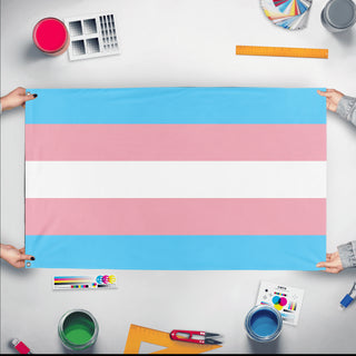 A mockup of the custom flag 'Transgender Flag' held up on a table during print checking