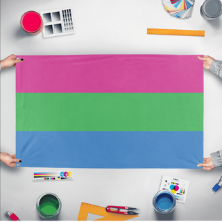 A mockup of the custom flag 'Polysexual Flag' held up on a table during print checking