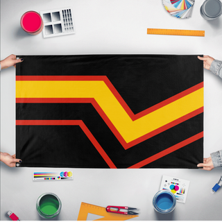A mockup of the custom flag 'Rubber Pride Flag' held up on a table during print checking