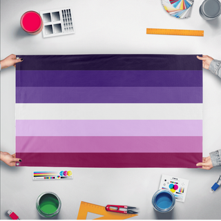 A mockup of the custom flag 'Moon Lesbian Flag' held up on a table during print checking