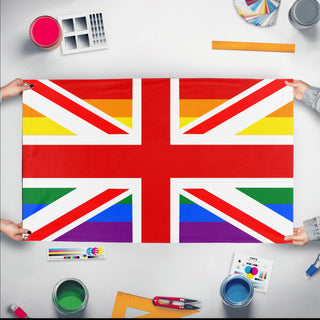 A mockup of the custom flag 'British Union Jack Pride Flag' held up on a table during print checking