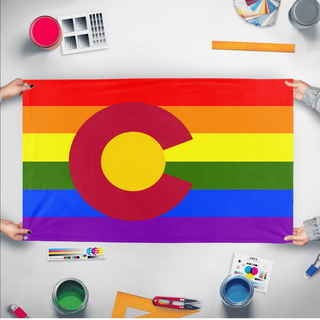 A mockup of the custom flag 'Colorado Pride Flag' held up on a table during print checking