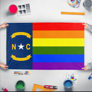 A mockup of the custom flag 'North Carolina Pride Flag' held up on a table during print checking