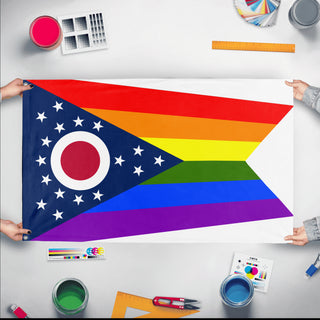 A mockup of the custom flag 'Ohio Pride Flag' held up on a table during print checking