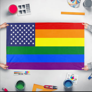 A mockup of the custom flag 'United States Pride Flag' held up on a table during print checking