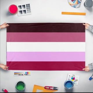 A mockup of the custom flag 'closeted lesbian flag' held up on a table during print checking