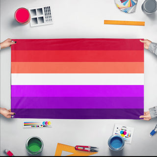 A mockup of the custom flag 'asexual lesbian flag' held up on a table during print checking