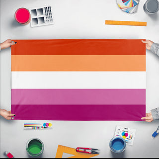 A mockup of the custom flag 'sapphic lesbian flag' held up on a table during print checking
