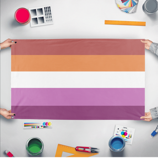 A mockup of the custom flag 'pastel lesbian flag' held up on a table during print checking