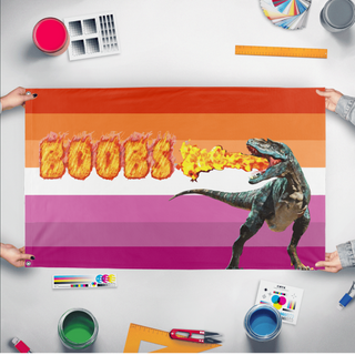 A mockup of the custom flag 'lesbian dinosaur flag' held up on a table during print checking