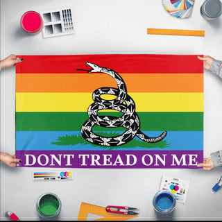 A mockup of the custom flag 'Gadsden Pride Flag' held up on a table during print checking